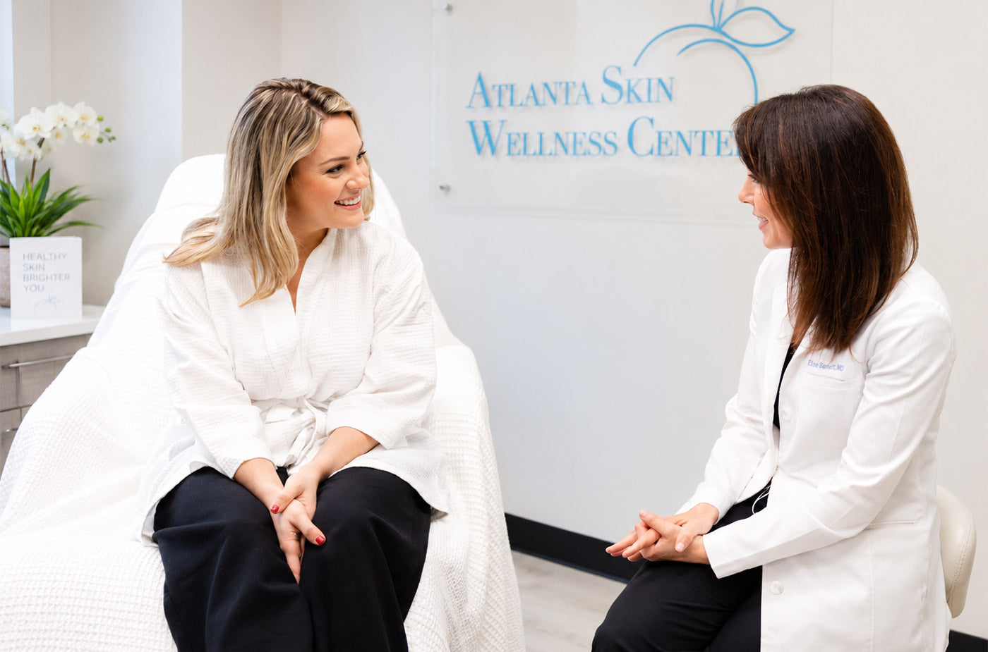 Dr. Elise Barnett discussing psoriasis and overall skin health with a patient at Atlanta Skin Wellness Center